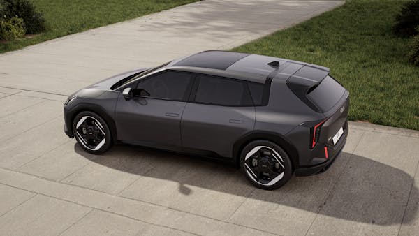 Kia EV4 electric car on driveway with grass in background