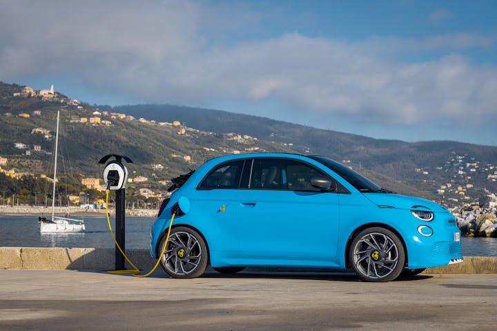 abarth 500e cabrio electric car in blue with scenic background