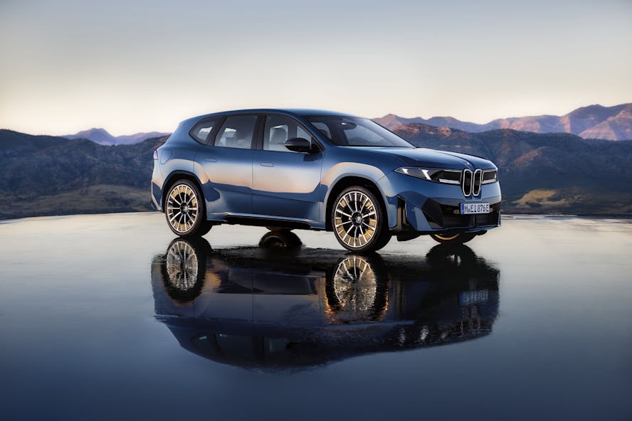 bmw ix3 updated model for 2025, with mountain background