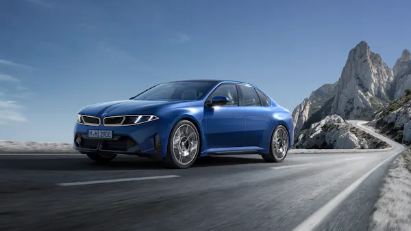 BMW i3 2026 Neue Klasse front view driving in mountains