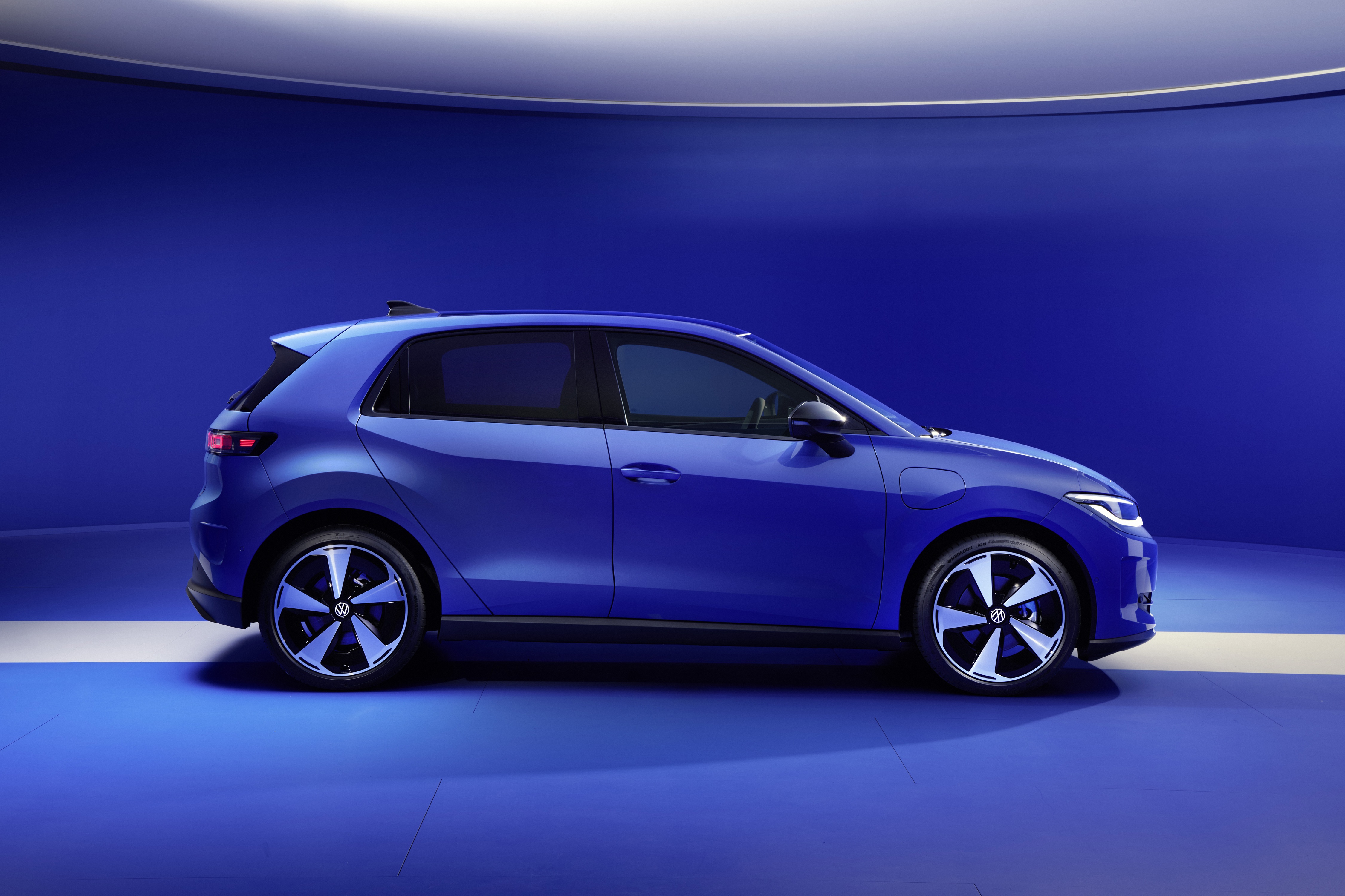 Volkswagen id polo electric car in bright blue side profile, with blue and white background