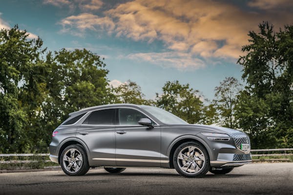 Genesis GV70 electric car with greenery in background