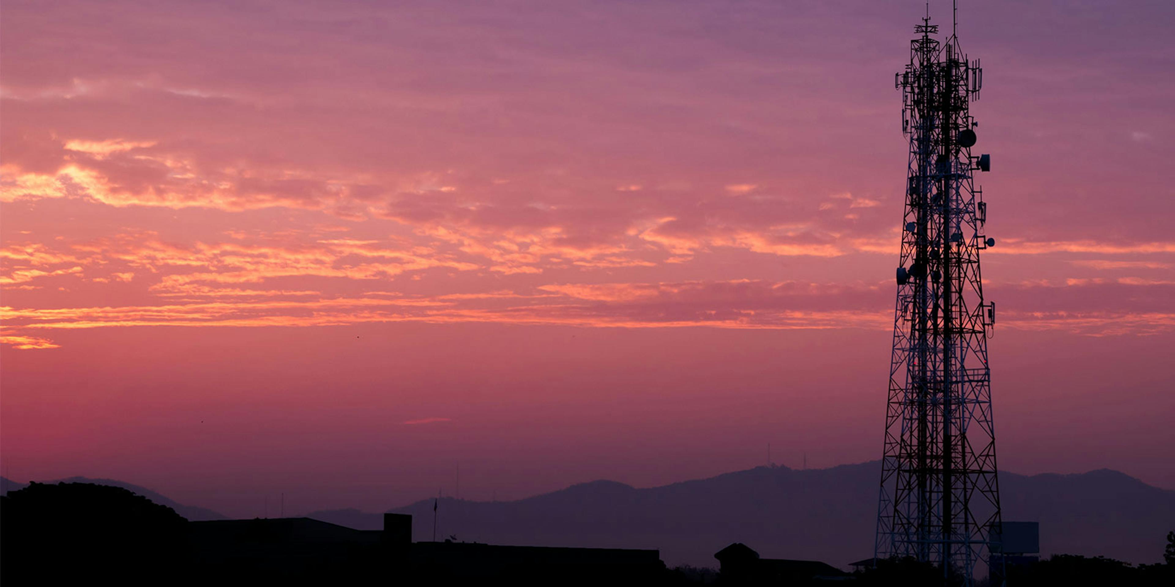 Direct Tower Services - Tower at sunrise over mountain view