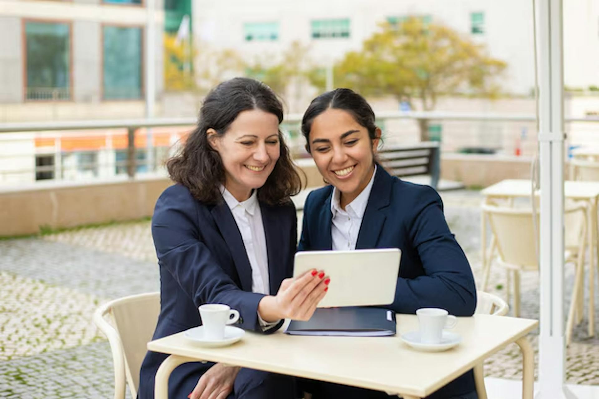two business women with a tablet in hand