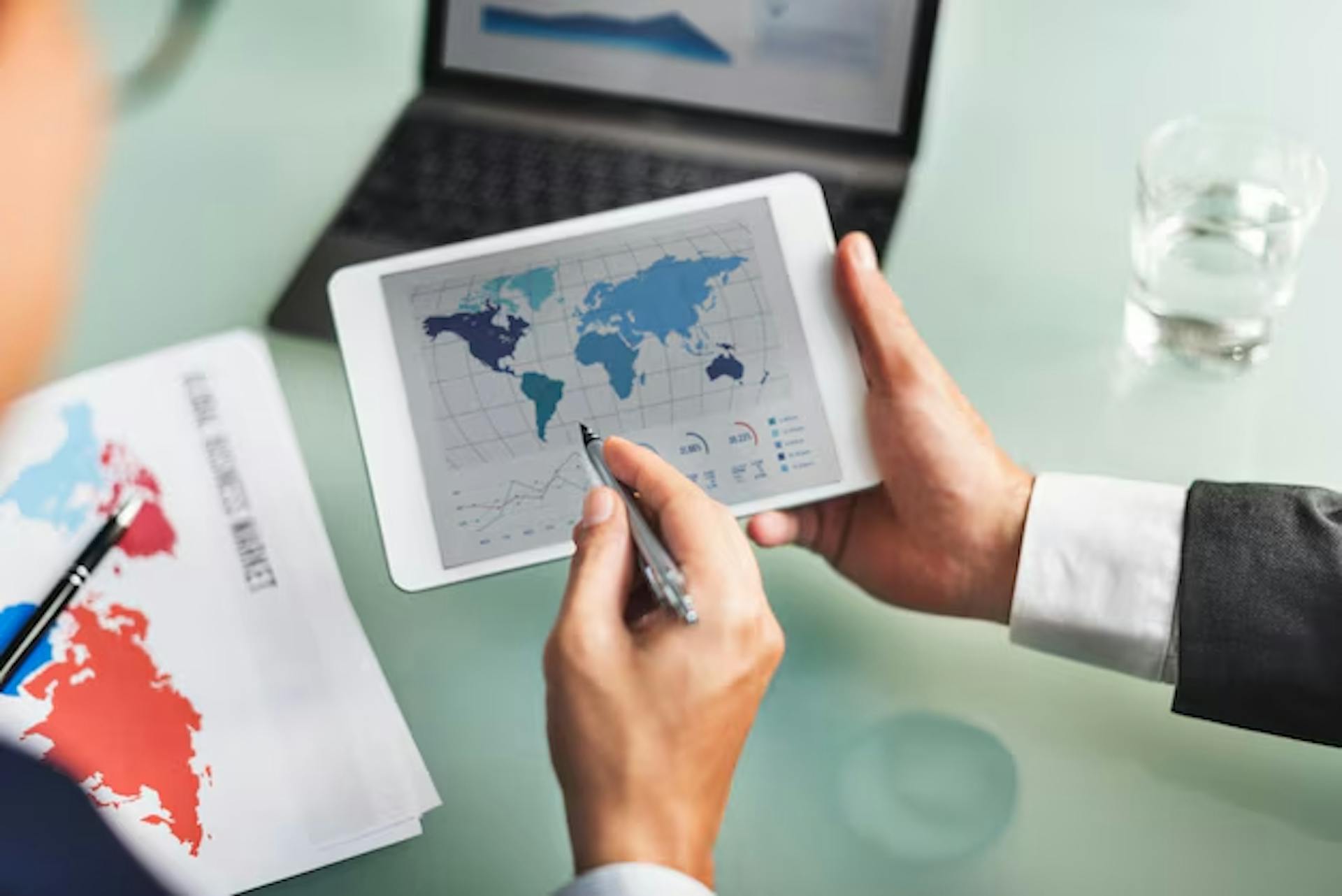 Business men checking data for a global project on a tablet