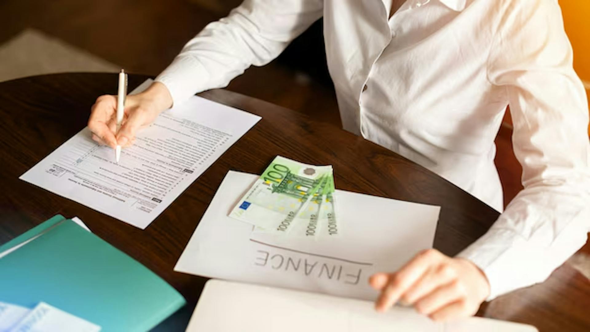 Woman working with finances on the table. Tax on foreign income of resident Indian.