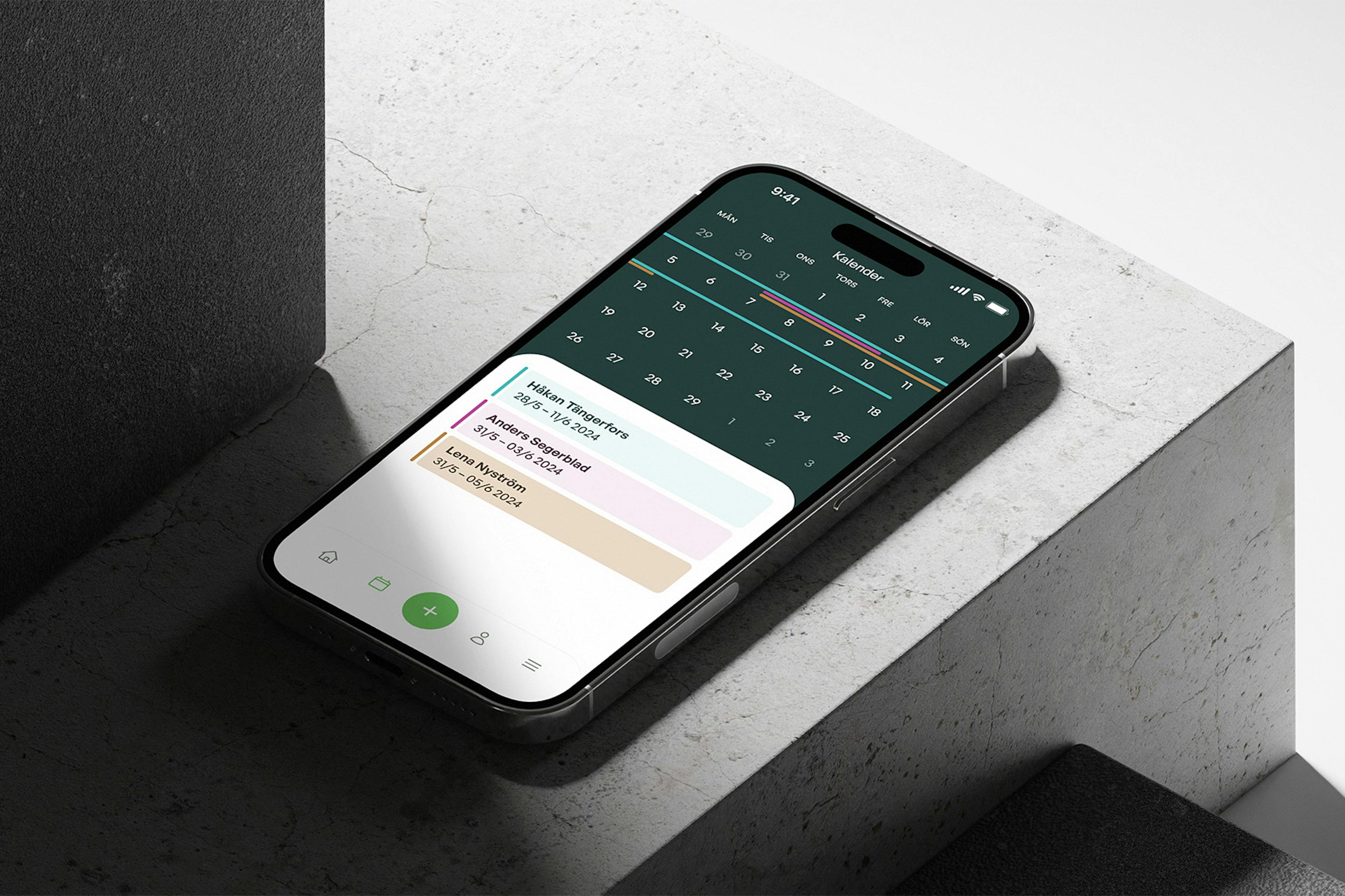 An iPhone 14 display the booking app in an industrial setup