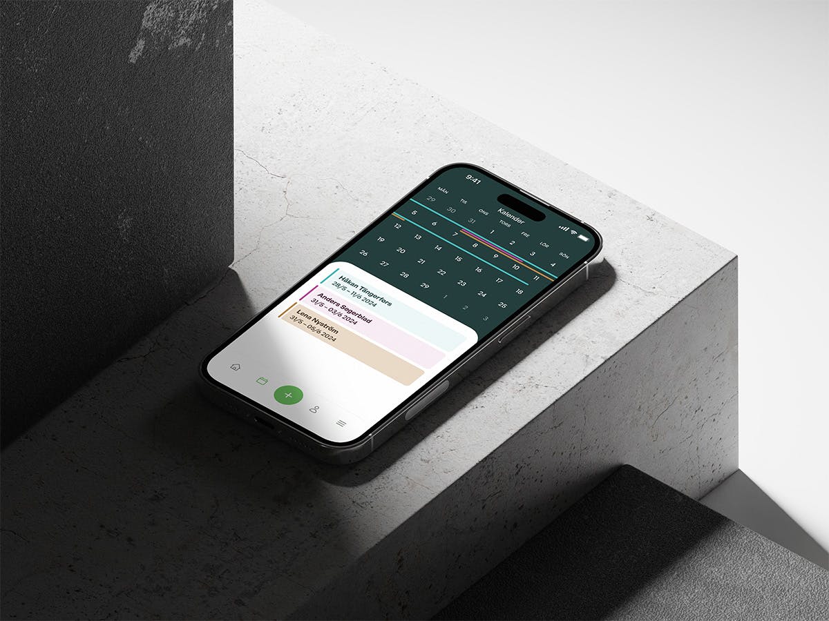 An iPhone 14 display the booking app in an industrial setup