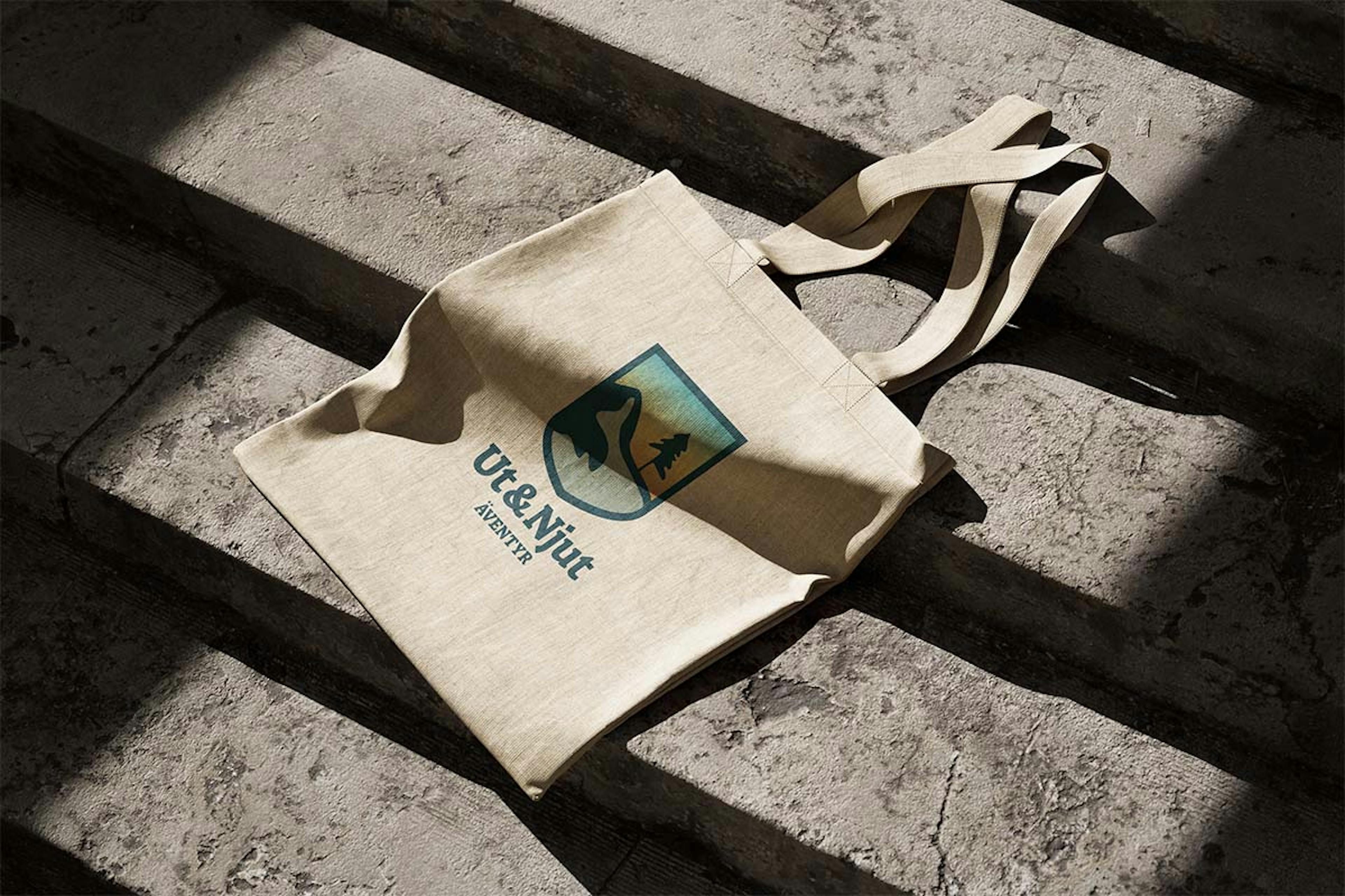 A nature colored tote bag lying on a concrete staircase