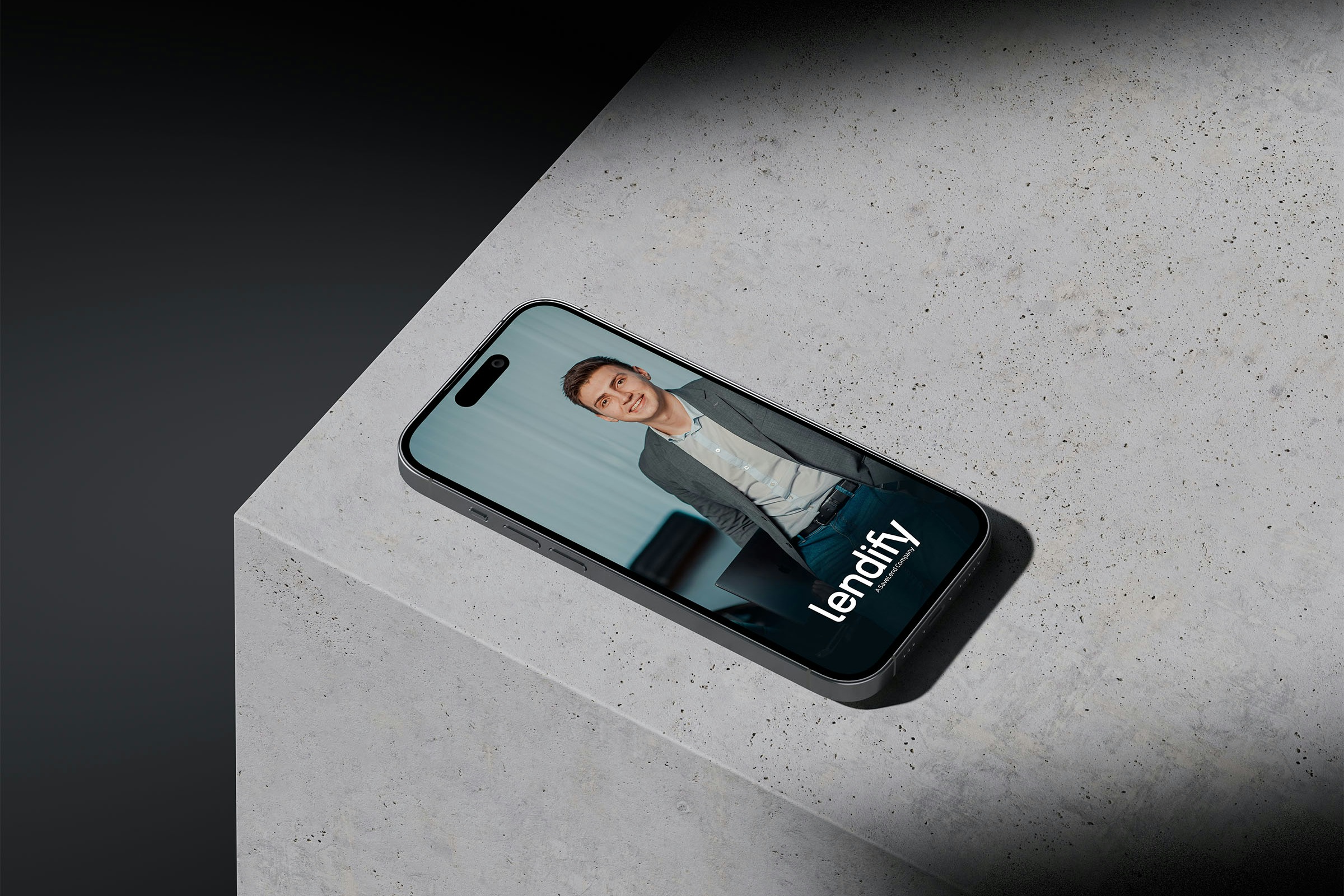 An iPhone sitting on a concrete surface displaying an Lendify ad