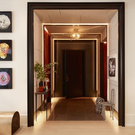 Tribeca Loft private entry with lights on, Chris Wolston Chair and Stool against right wall below Jean Dubuffet painting