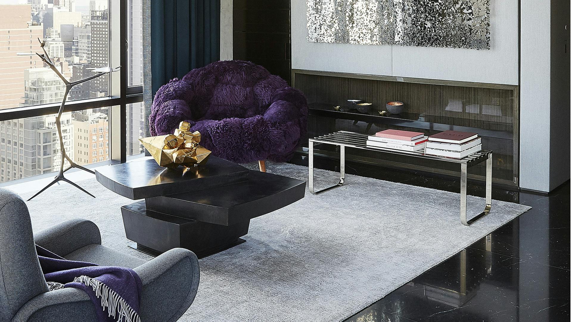 Media area at Place 57 with contemporary and vintage chairs and mirrored wall art 