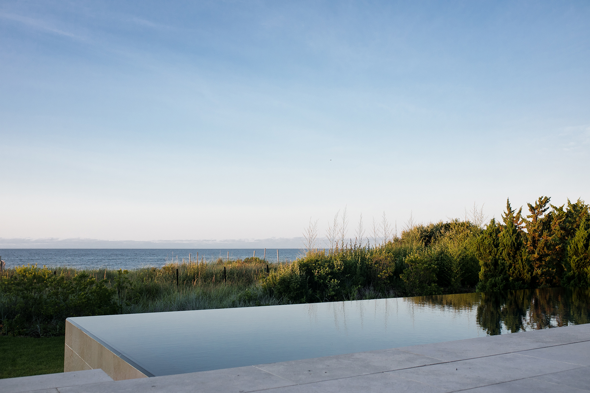 Infinity pool view facing vegetation and ocean