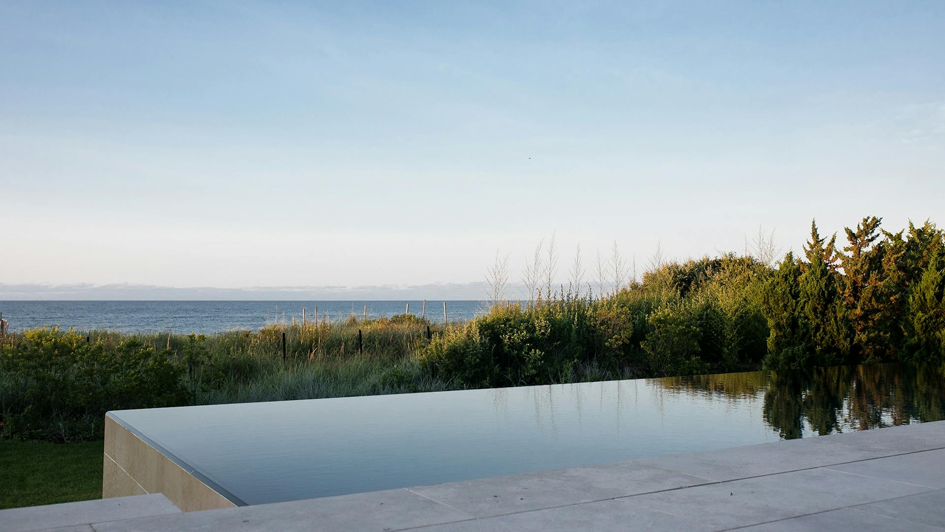 Infinity pool view facing vegetation and ocean