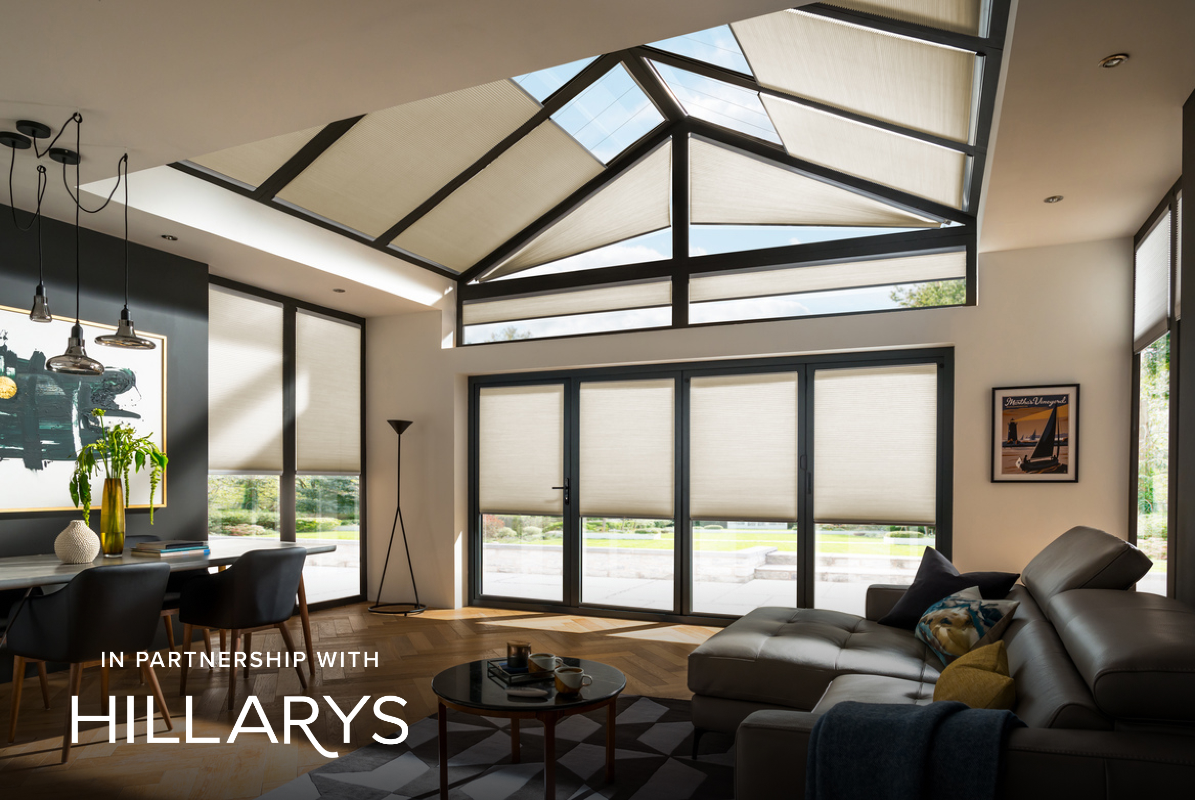 Cream Duette® blinds on large windows in a modern living room