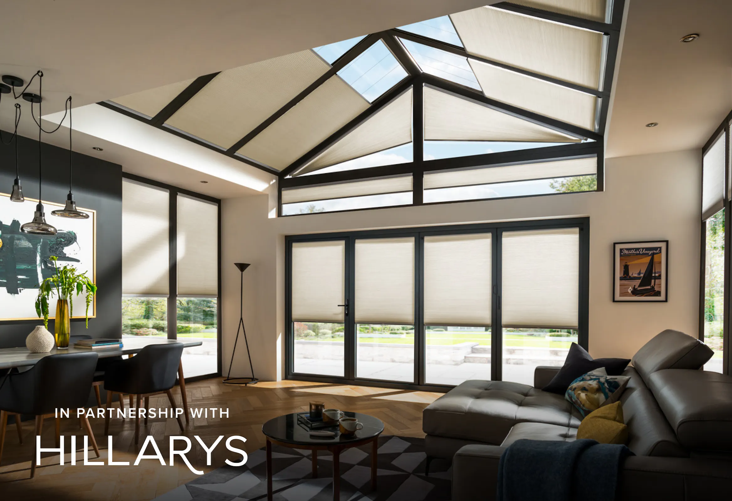 Cream Duette® blinds on large windows in a modern living room
