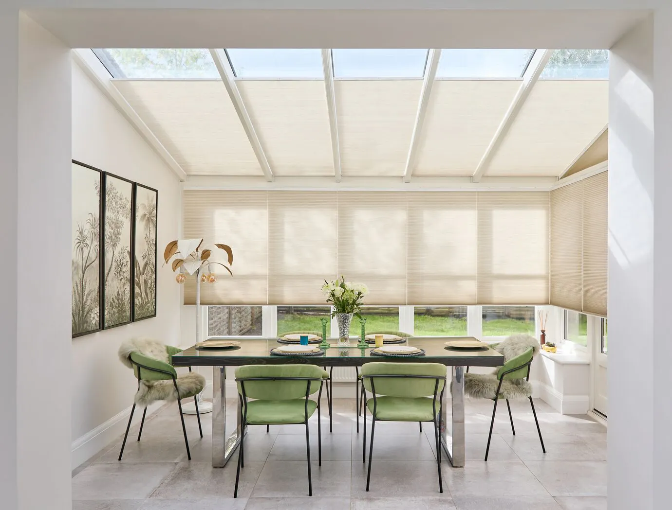 Cream Duette® honeycomb blinds on large wall and roof windows in a light dining room