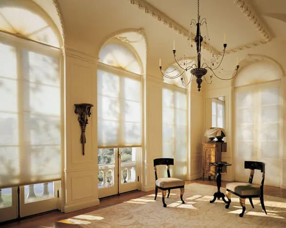 Light cream Duette® honeycomb blinds on large windows in a period home  