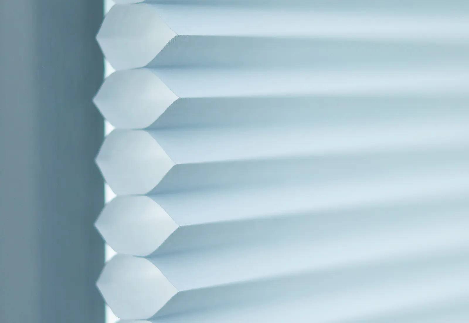 Close-up of light blue Duette® honeycomb blinds
