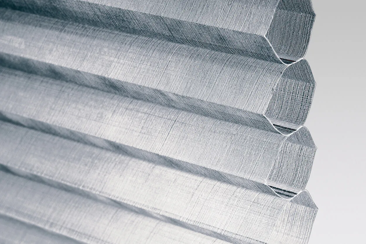 Close‑up of grey Duette® honeycomb fabric showing its textured material and cell structure.