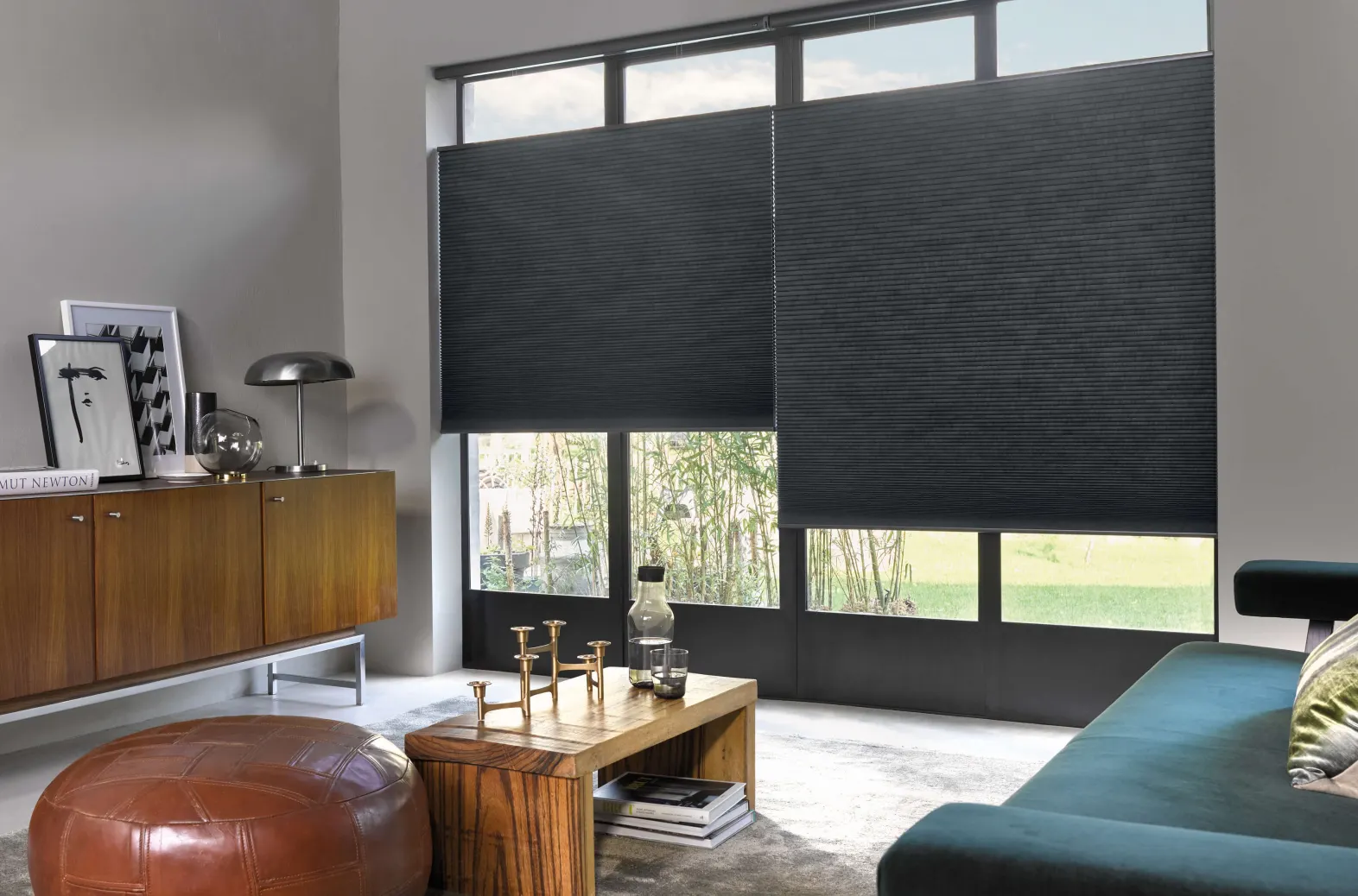 Dark grey Duette® honeycomb blinds on tall patio doors in a modern living room.