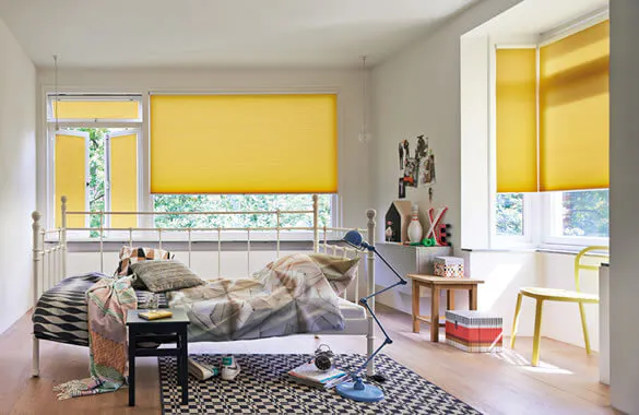 Yellow Duette® honeycomb blinds in a bright children's room