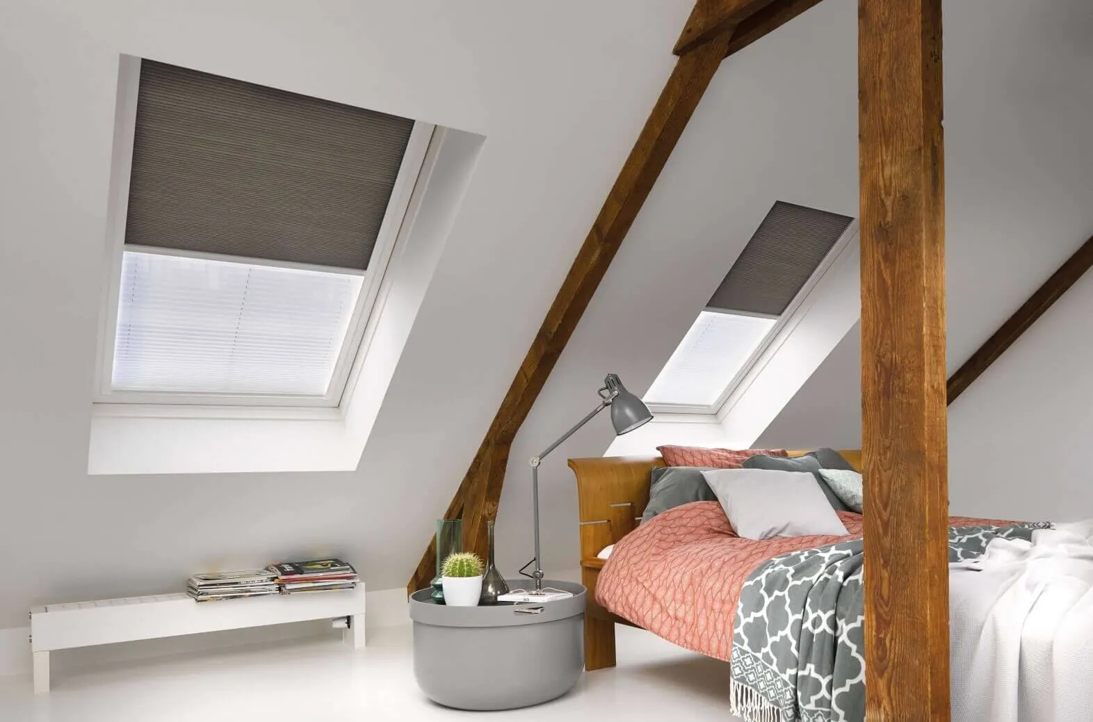 Close up of a simple loft conversion bedroom with skylights fitted with Duette blackout blinds