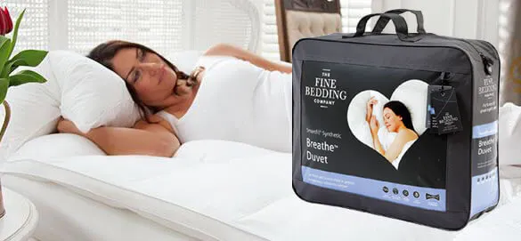 A woman sleeping in white fine bedding sheets