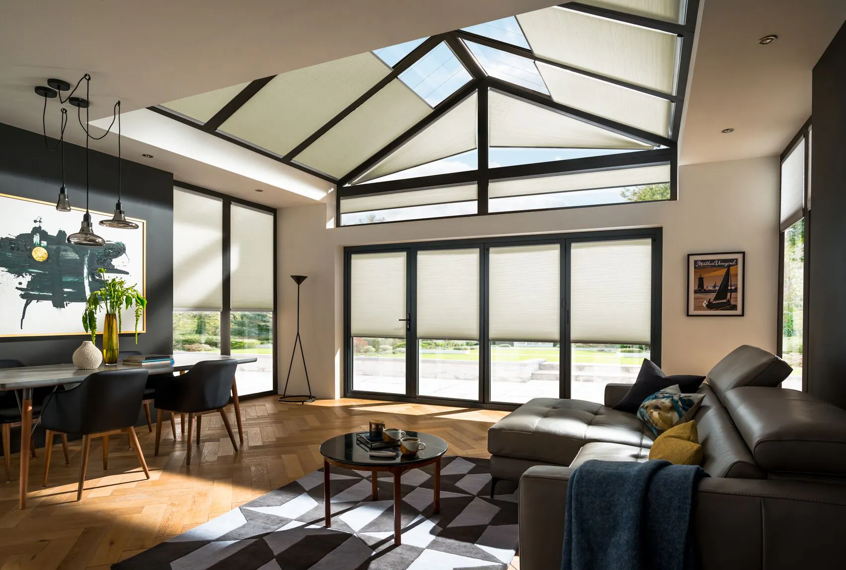 Cream Duette® honeycomb blinds on bi fold doors and roof windows in living room