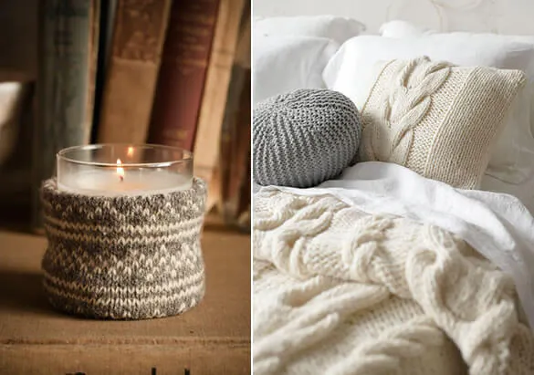 Close up of a candle and cosy bed with knitted throws and blankets