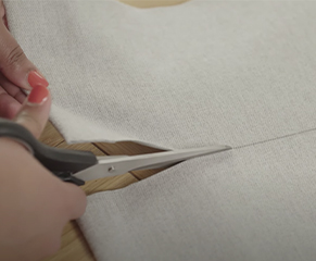 4. Use a craft knife or sharp pair of scissors to carefully cut the fabric, and a hacksaw to trim the bottom bar. 