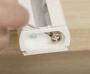 9. Place the end cap in the headrail and the locking ring back on the tilt rod before securing with the provided Allen key.