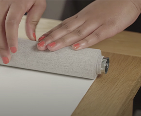 6. Roll the blind back up tightly, keeping the edges straight and aligned.