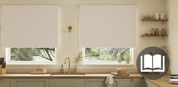 White roller blind in a green and cream kitchen