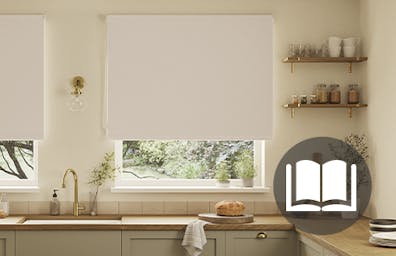 White roller blind in a green and cream kitchen