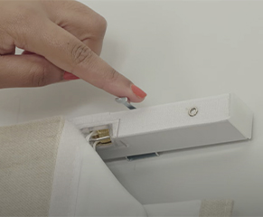 3. When you are happy, lock the swing arms on the end brackets to secure the blind in place.