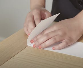 12. Transfer this measurement to the fabric vane and fold the fabric over the plastic rod. Ensure that the fabric is folded in the same direction as the bottom pocket and slide the folded vane into a vane hanger.