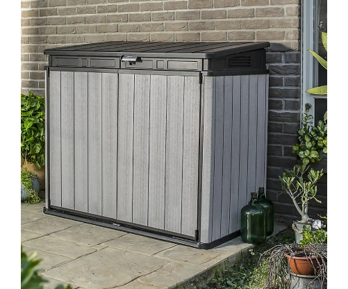 Garden storage unit in an outdoor setting, used to store outdoor accessories.