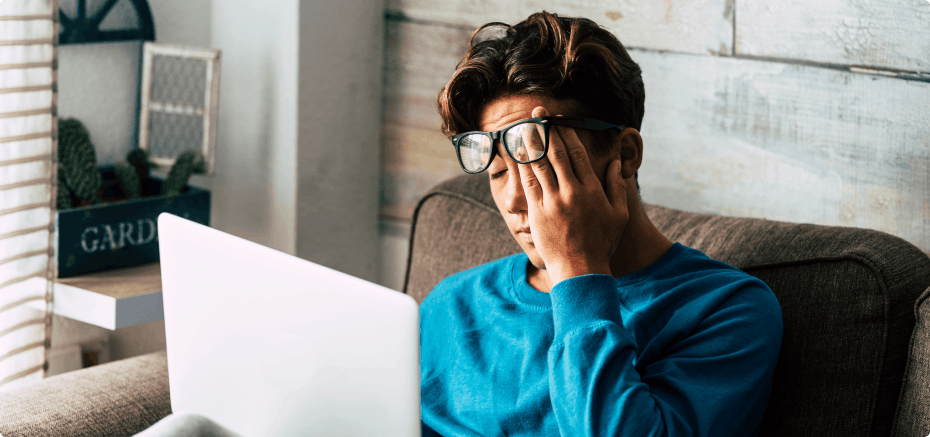 Tired student studying with a laptop