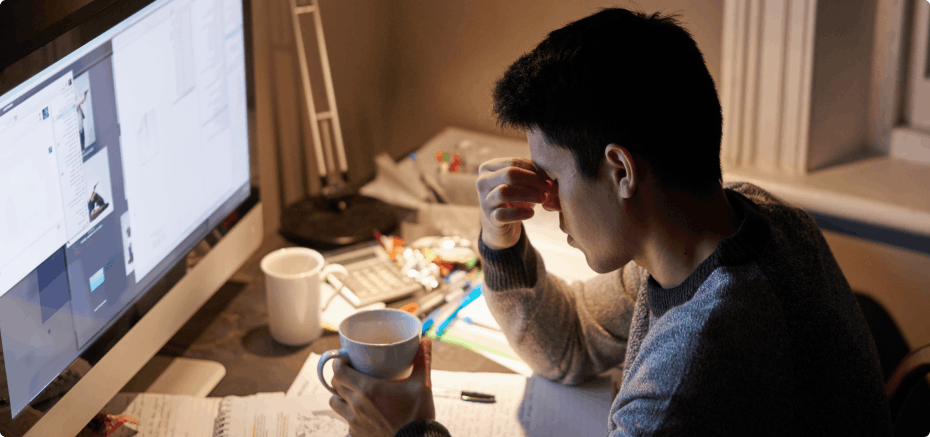 Tired student studying at a desk late at night