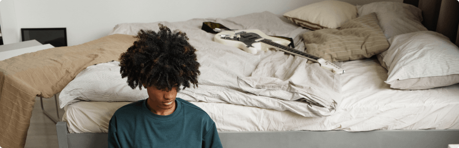 Students sitting next to a bed