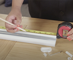 5. Remove the locking ring and the plastic end cap before using pliers to remove the plastic locking ring found by the end glider and keeping it to one side. Slide all gliders towards the wand control end. Mark the length of the blind required, starting from the wand control end.