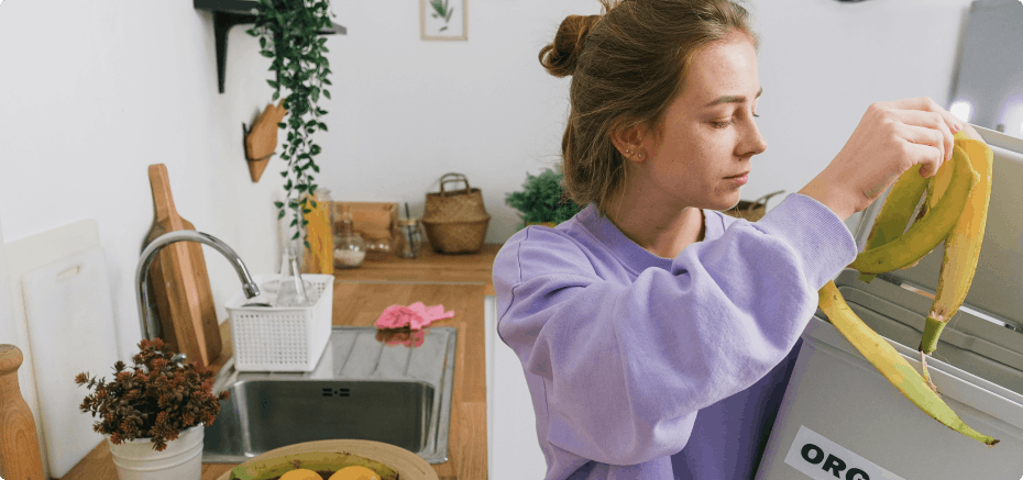 Woman throwing away food waste into the correct bin