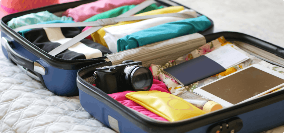 Suitcases open with folded clothes packed inside