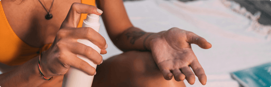 Woman applying suncream