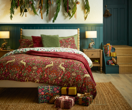 Festive bedroom with a bed that has Christmas bedding