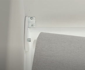 8. To fit the blind at your window, place the pivot end first. This has a spring for easy installation and the other side can just be pushed into place.