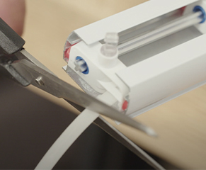 7. Carefully pull the gliders back to their original location, depending on the width of the cut, some gliders may come off the headrail. If gliders are outside the headrail, cut the plastic link as near as possible to the last glider inside the rail using scissors. 