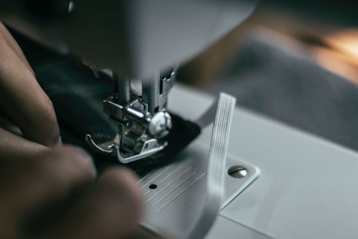  close up of sewing machine with thin elastic
