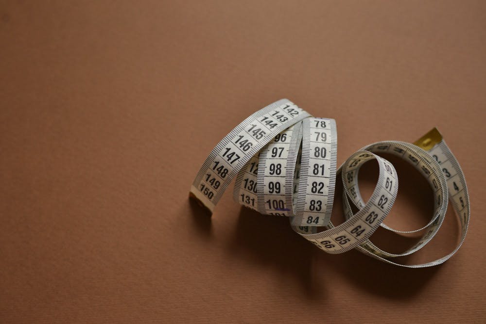 measuring tape on brown background